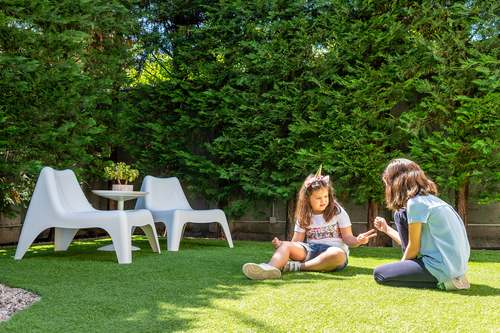 Children play in the Kalamata Mediterranean Villas garden